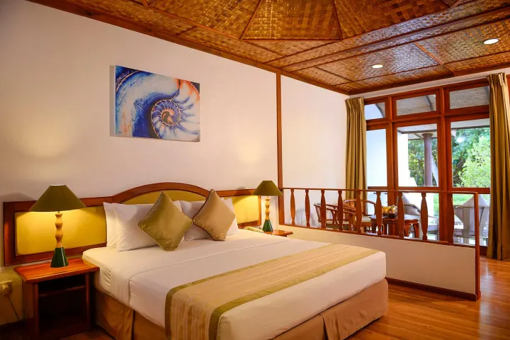 Bandos Maldives — спальня с плетеной крышей и террасой