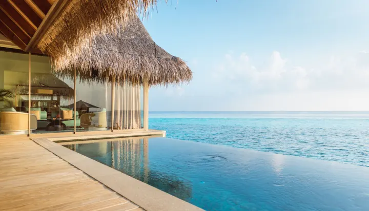 Joali Maldives — длинный пейзажный бассейн на террасе над водой