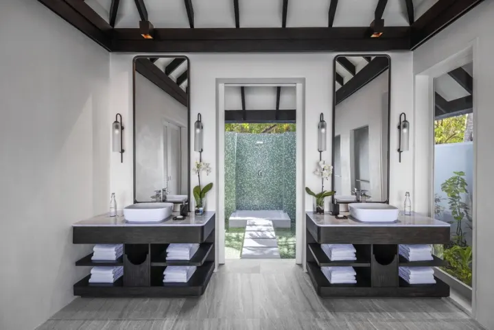 Naladhu Private Island Maldives — роскошная ванная комната с глубокой ванной и видом на приватный бассейн