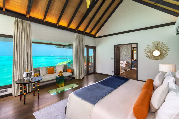OZEN Life Maadhoo, Мальдивы — интерьер виллы OZEN Life Maadhoo — светлая спальня с панорамным окном и видом на океан