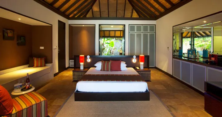 Velassaru Maldives — элегантная пляжная вилла с шезлонгами среди пальм